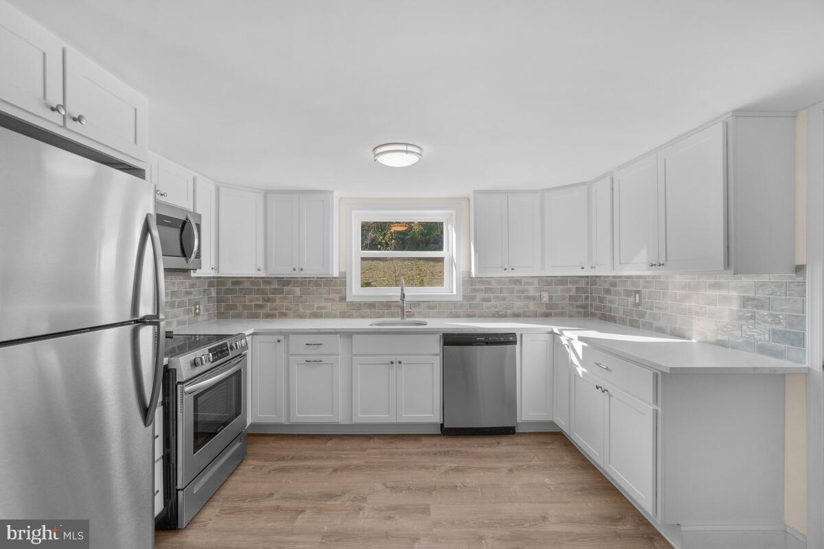 332 Ridge Road, Unit A Westminster, MD 21157 - Photo 4 of 21 a kitchen with a sink stove and refrigerator