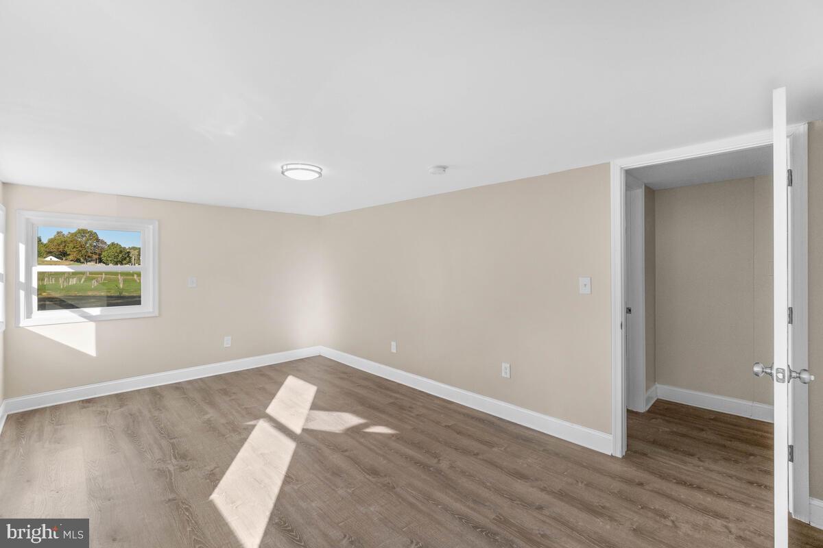 332 Ridge Road, Unit A Westminster, MD 21157 - Photo 6 of 21 an empty room with wooden floor and window