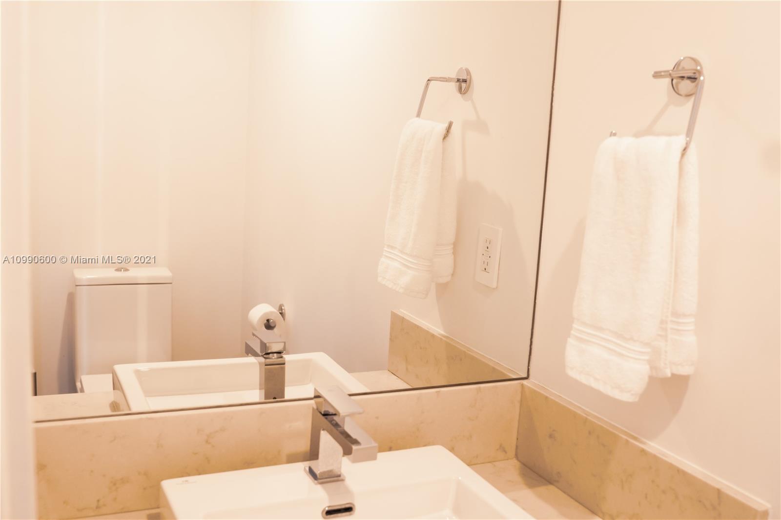 1080 Brickell Avenue, Unit 3702 Miami, FL 33131 - Photo 12 of 39 a bathroom with a bathtub and a shower