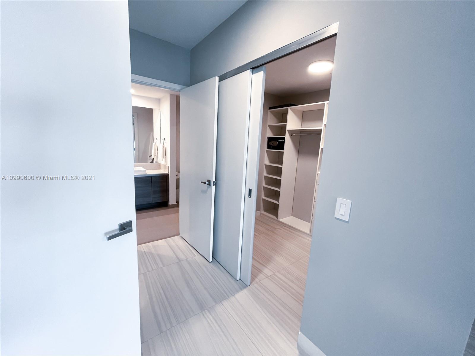 1080 Brickell Avenue, Unit 3702 Miami, FL 33131 - Photo 16 of 39 a view of hallway with wooden floor