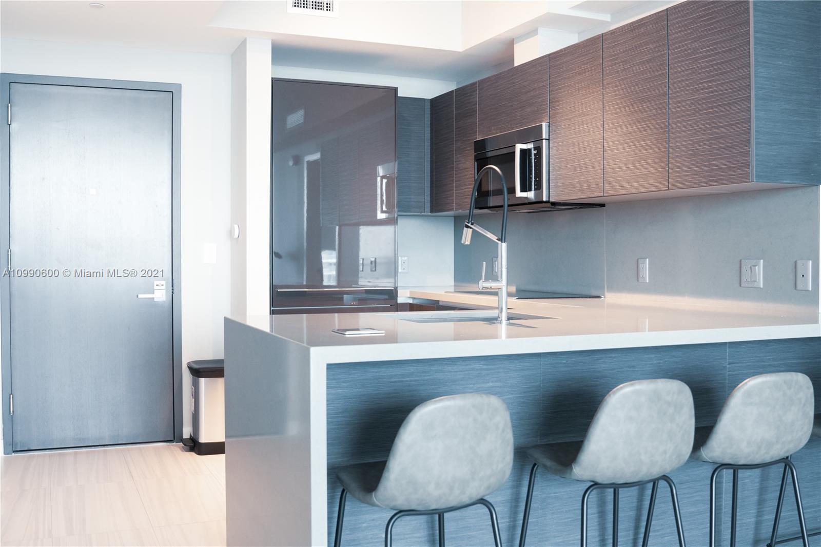 1080 Brickell Avenue, Unit 3702 Miami, FL 33131 - Photo 2 of 39 a kitchen with stainless steel appliances granite countertop a sink and a refrigerator