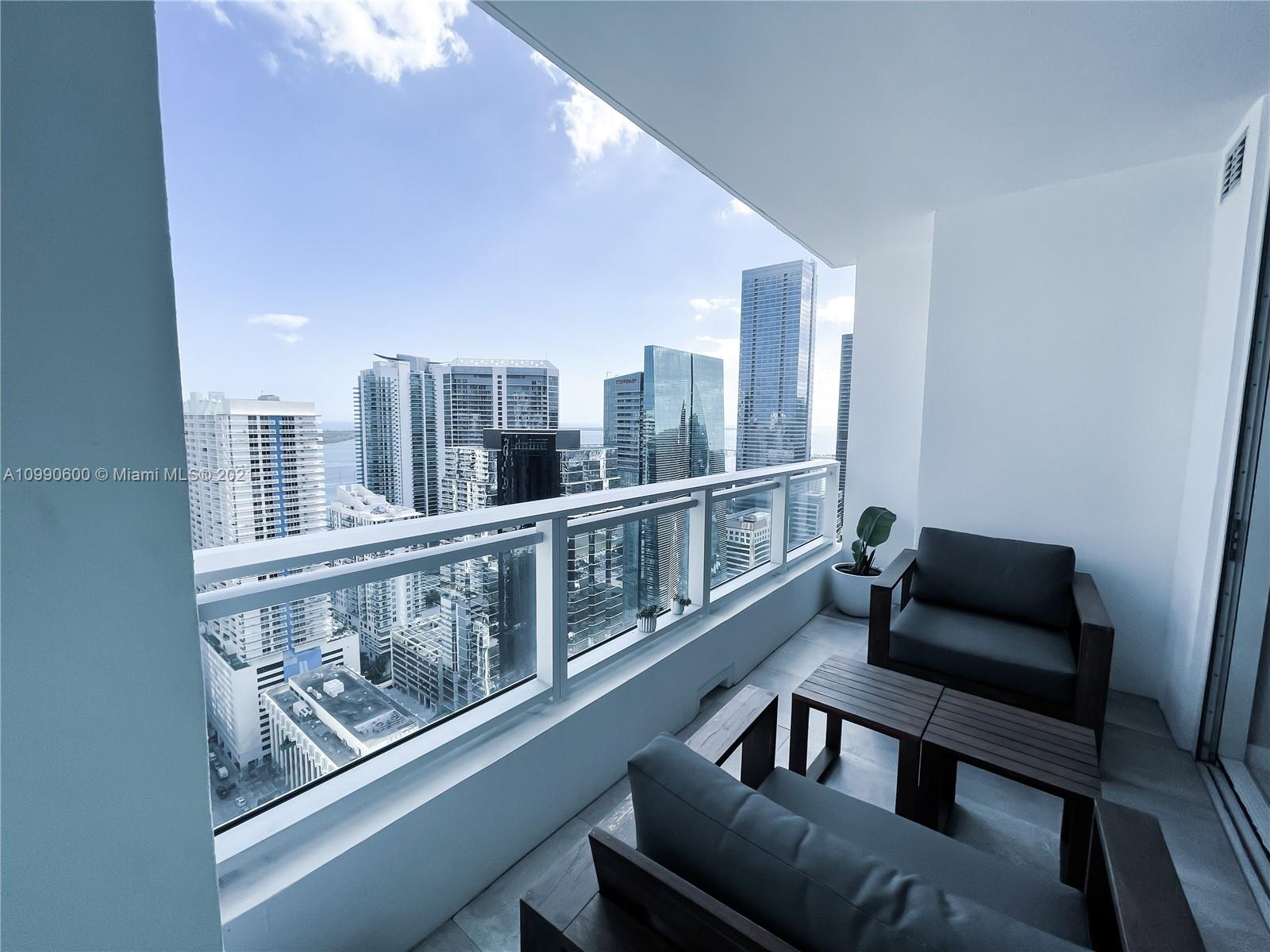 1080 Brickell Avenue, Unit 3702 Miami, FL 33131 - Photo 24 of 39 a living room with furniture and a window