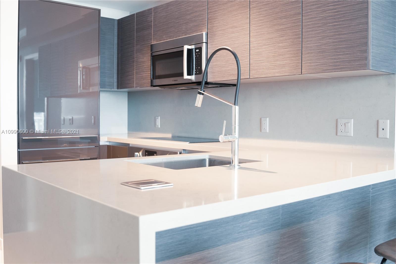 1080 Brickell Avenue, Unit 3702 Miami, FL 33131 - Photo 6 of 39 a kitchen with a sink a stove and cabinets