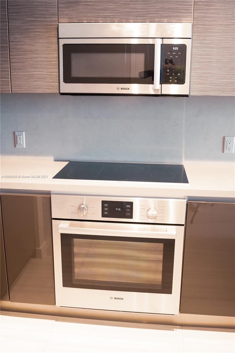 1080 Brickell Avenue, Unit 3702 Miami, FL 33131 - Photo 7 of 39 a stove top oven sitting inside of a kitchen