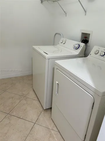 a view with granite countertop a sink and a stove