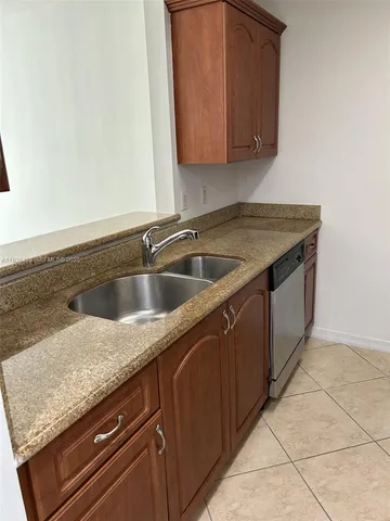 a kitchen with granite countertop a stove and a microwave