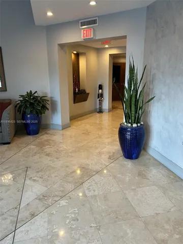 a view of a hallway with potted plant in front of a room