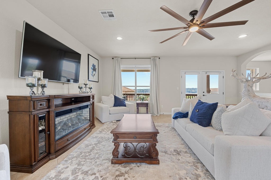 302 Southwind Road Lago Vista, TX 78645 - Photo 13 of 39 a living room with furniture and a flat screen tv