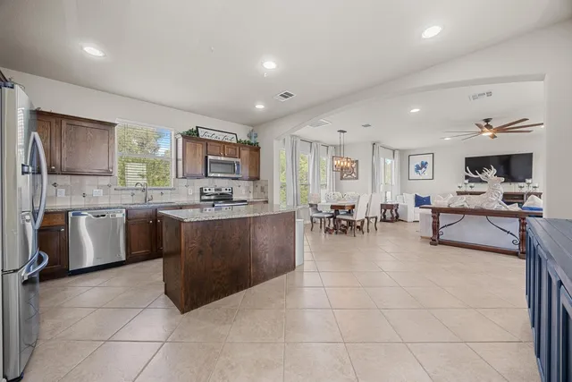 a view of swimming pool with seating space and barbeque oven in the back