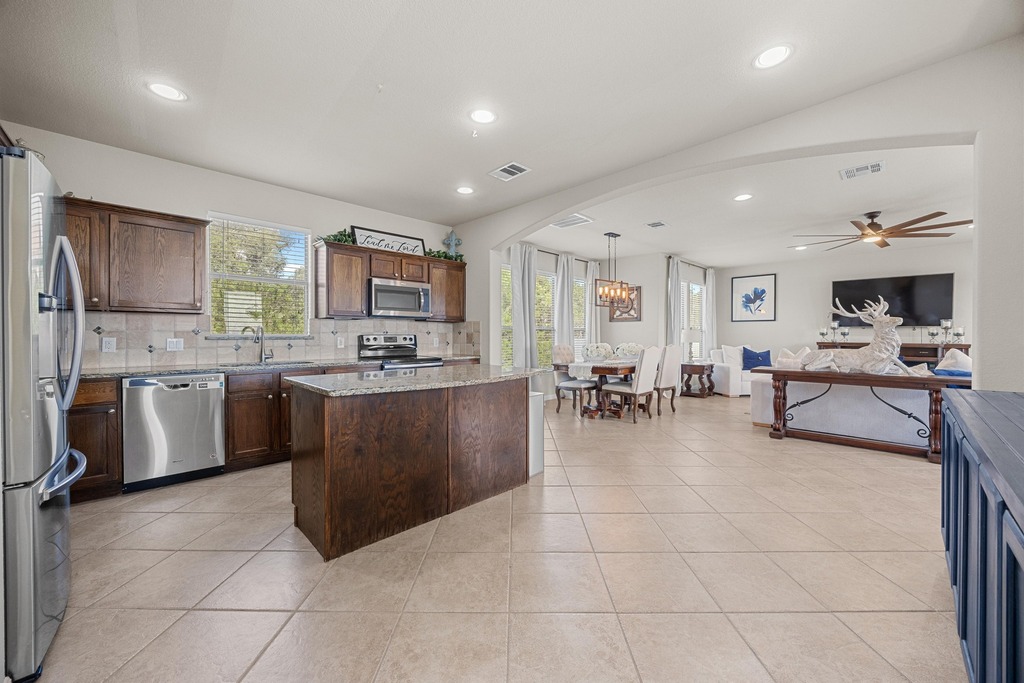 302 Southwind Road Lago Vista, TX 78645 - Photo 38 of 39 a kitchen with stainless steel appliances granite countertop a stove sink and cabinets