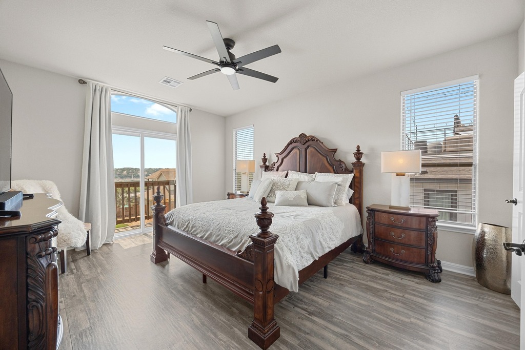 302 Southwind Road Lago Vista, TX 78645 - Photo 21 of 39 a spacious bedroom with a bed and wooden floor
