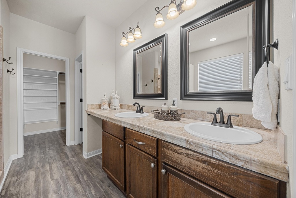 302 Southwind Road Lago Vista, TX 78645 - Photo 23 of 39 a bathroom with a sink double vanity granite and a mirror