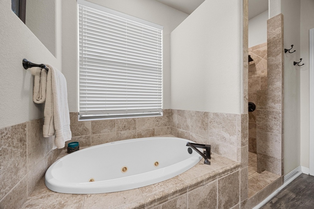 302 Southwind Road Lago Vista, TX 78645 - Photo 24 of 39 a bathroom with a tub and shower