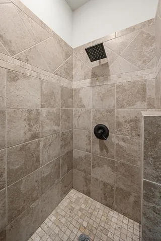 a bathroom with a tub and shower