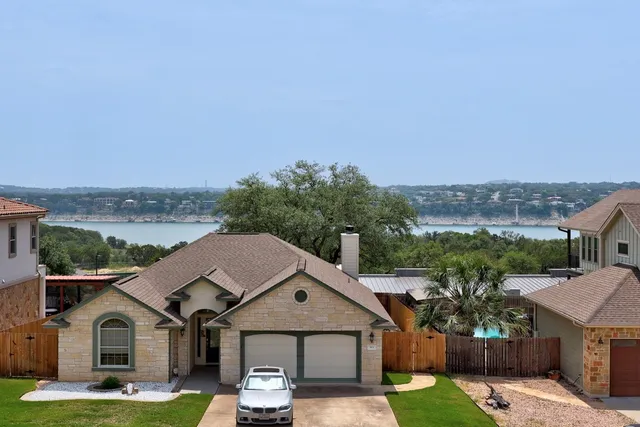 a backyard of a house with table and chairs
