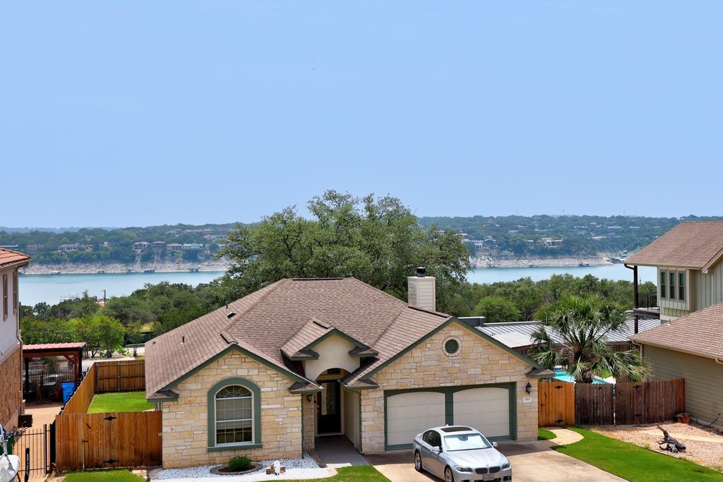 302 Southwind Road Lago Vista, TX 78645 - Photo 34 of 39 a front view of a house with a yard and garage