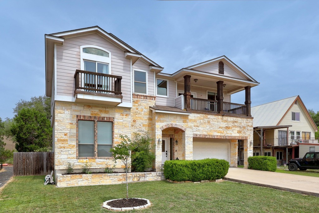 302 Southwind Road Lago Vista, TX 78645 - Photo 4 of 39 a front view of a house with a yard