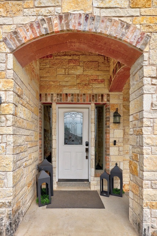 302 Southwind Road Lago Vista, TX 78645 - Photo 5 of 39 a front view of a building with potted plants