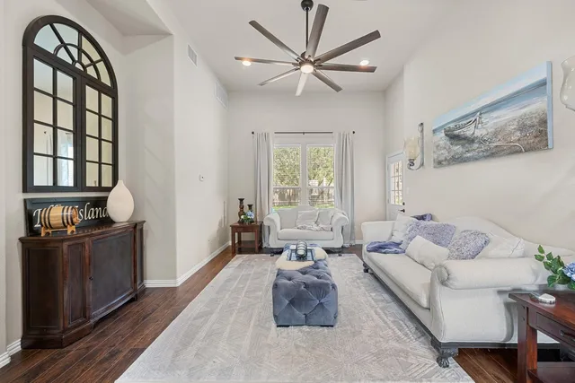 a living room with furniture fireplace and a window