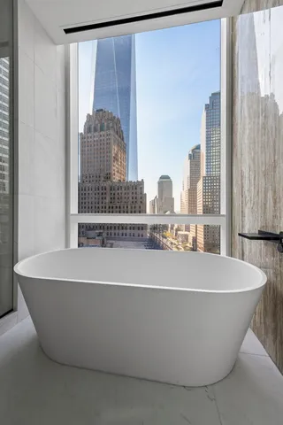 a hallway with a large window and couch