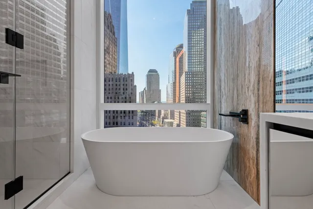 a white bath tub sitting in front of a window