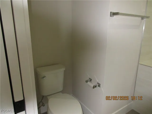 a white toilet sitting next to a sink