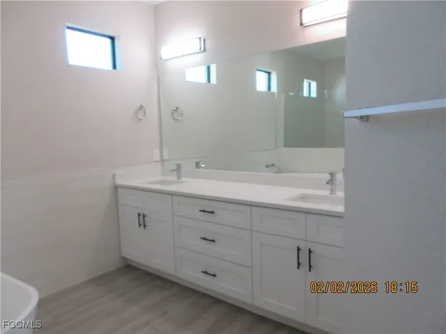 a bathroom with a sink double vanity and a mirror