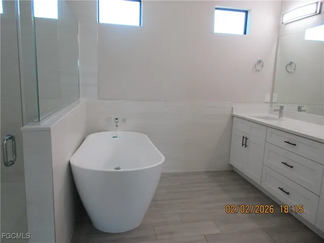a white bath tub sitting in a bathroom