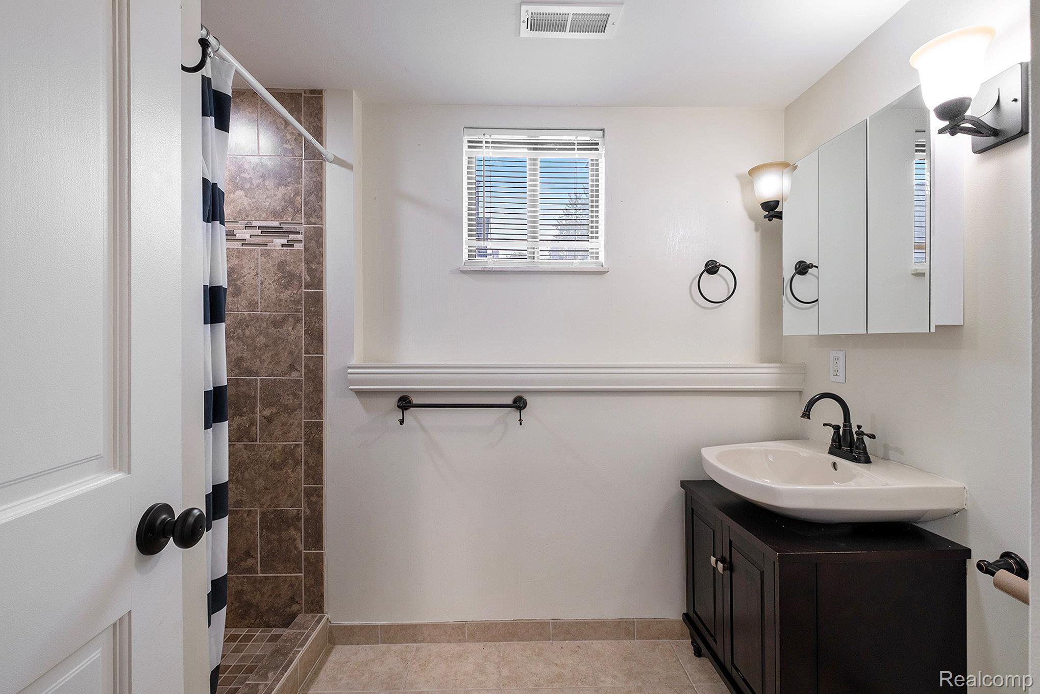 12147 Torrey Road Fenton, MI 48430 - Photo 14 of 19 Full bath with vanity, a stall shower, and light tile patterned floors