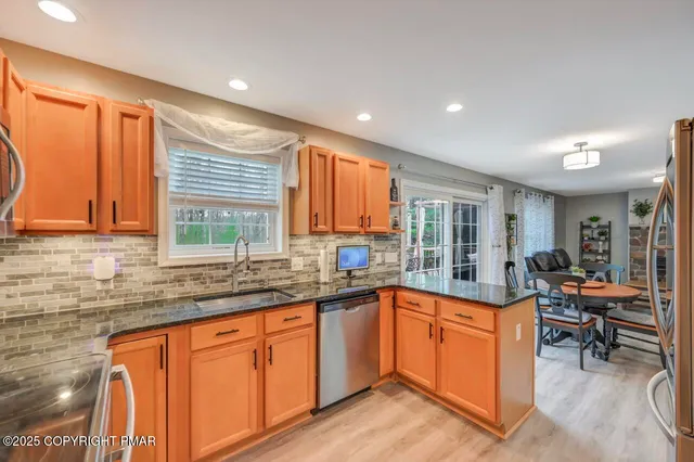 a view of a house with a yard and large tree