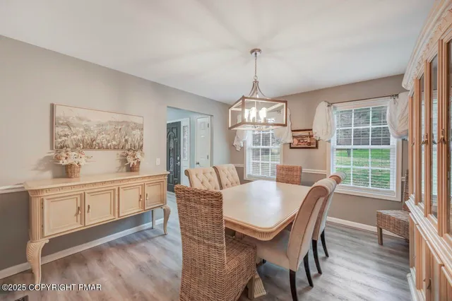 a view of a dining room with furniture window and wooden floor