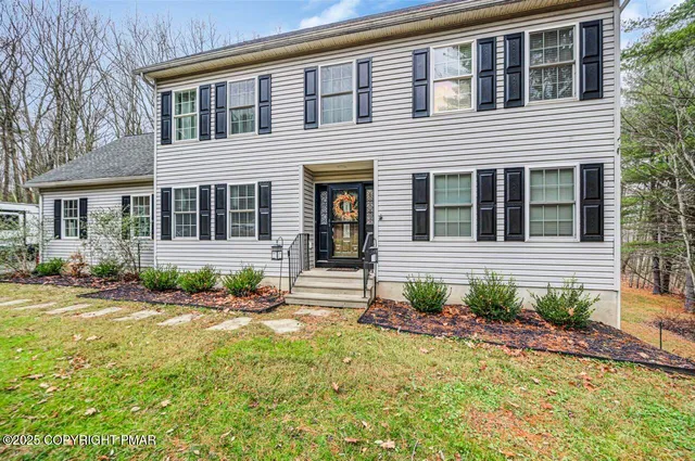 a front view of a house with garden
