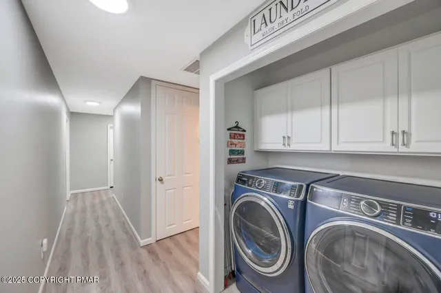 a view of storage and utility room with washer and dryer