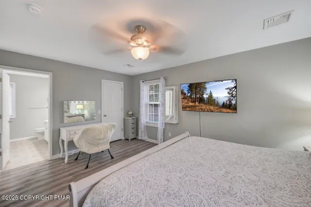 a spacious bedroom with a bed and a chandelier