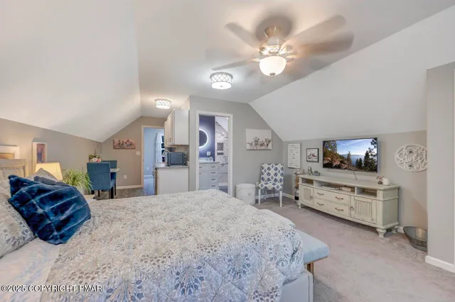 a large bedroom with a bed and dresser