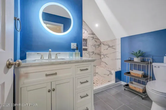 a bathroom with a sink a toilet and a mirror