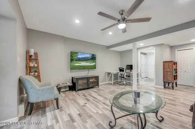 a living room with furniture and a flat screen tv