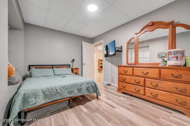 a bedroom with a bed and a dresser