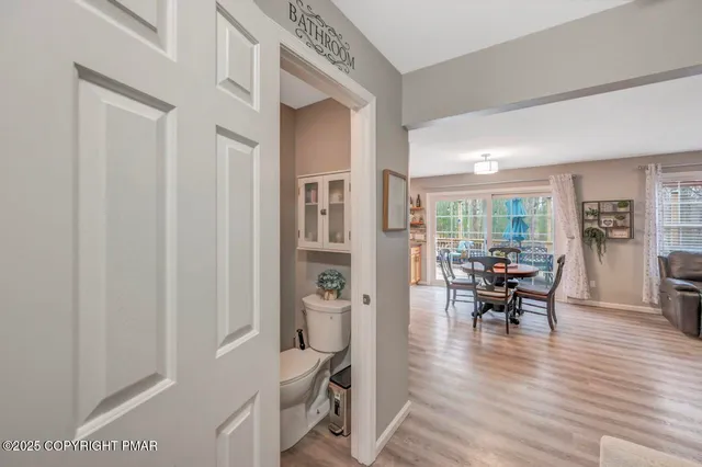 a dining room with furniture and wooden floor