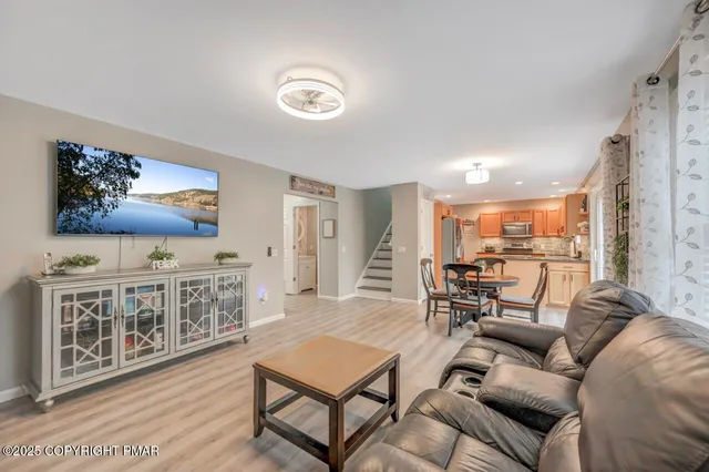 a view of a workspace with furniture and wooden floor