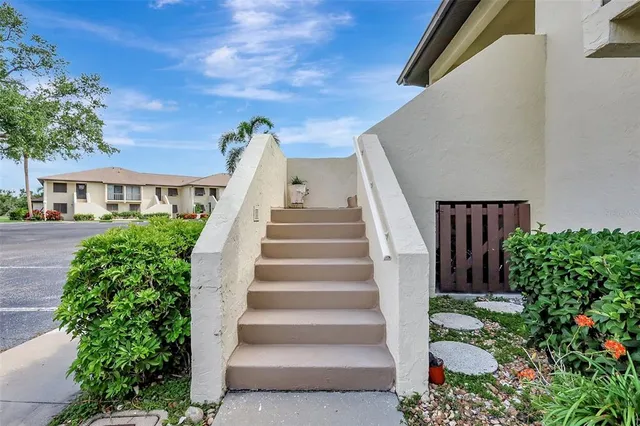 a view of a hallway with wooden floor and entryway