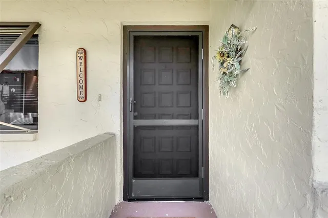 a kitchen with stainless steel appliances granite countertop a refrigerator a sink dishwasher a stove and white countertops with wooden floor