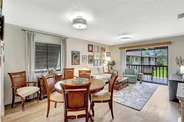 a dining room with furniture and wooden floor