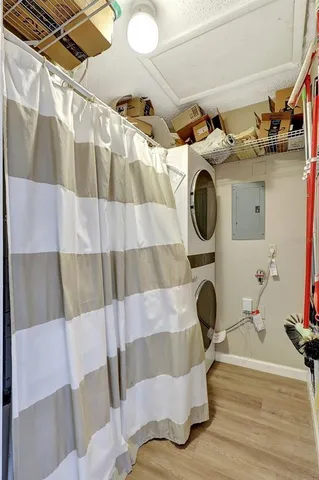 an aerial view of residential houses with outdoor space and lake view in back