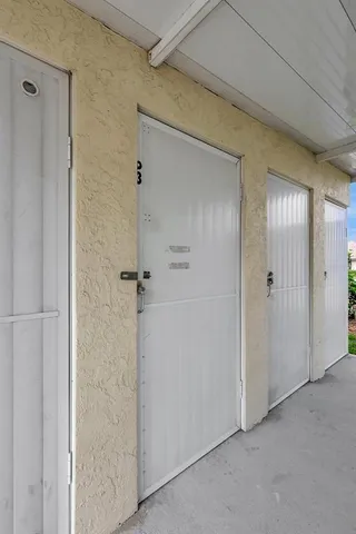 an aerial view of a city with lots of residential buildings ocean and mountain view in back