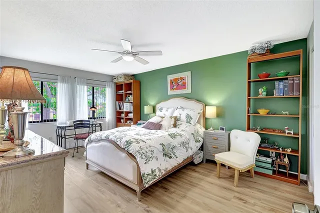 a view of a house with pool and chairs