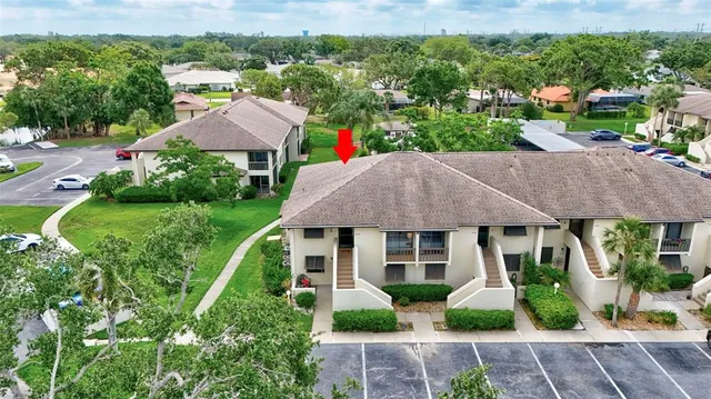 an aerial view of residential houses with outdoor space and street view