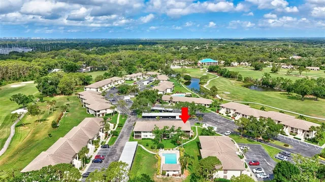 a view of a house with a swimming pool and a yard
