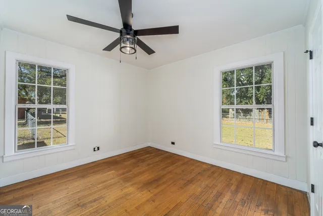 a view of a room with a window and a ceiling fan