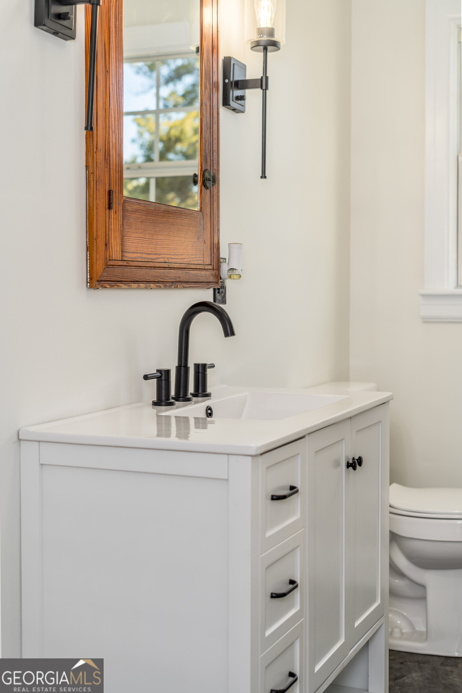 322 McGregor Street Blackshear, GA 31516 - Photo 19 of 30 a bathroom with a sink a toilet and a mirror